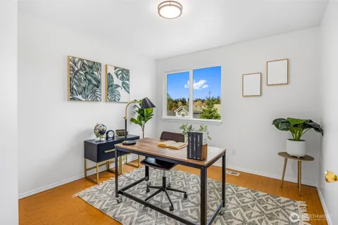 a workspace with furniture and painting on the wall