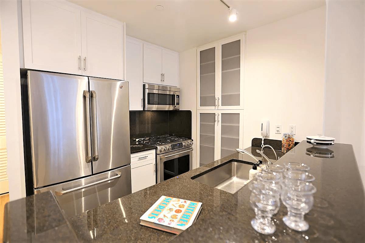 a living room with furniture a flat screen tv and a refrigerator