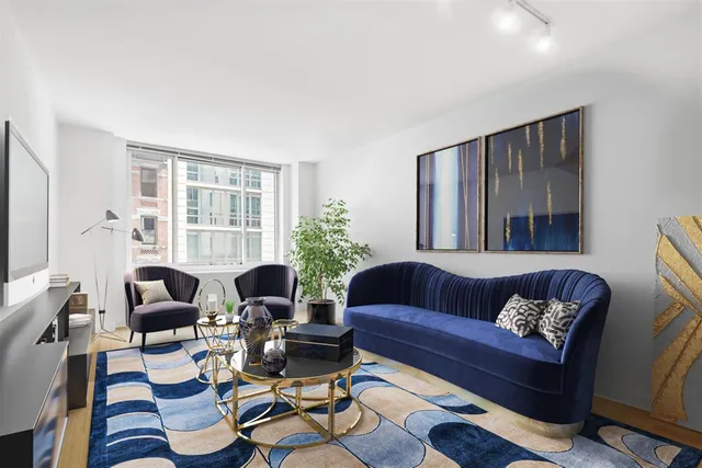 a living room with furniture fireplace and a large window