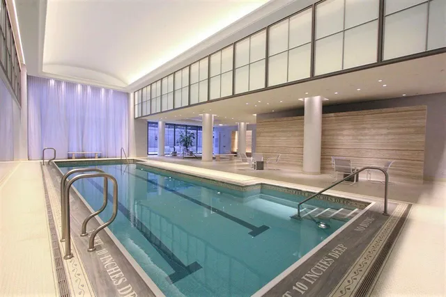 a view of a kitchen with kitchen island granite countertop a sink and a large window