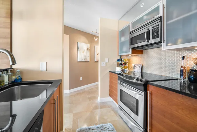 a large bed sitting in a bedroom next to a window