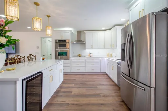 a kitchen with stainless steel appliances a stove a microwave and cabinets