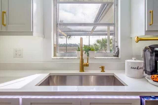 a kitchen with counter top space stainless steel appliances and wooden floor