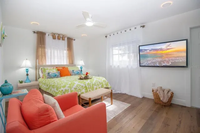 a bedroom with a bed and wooden floor