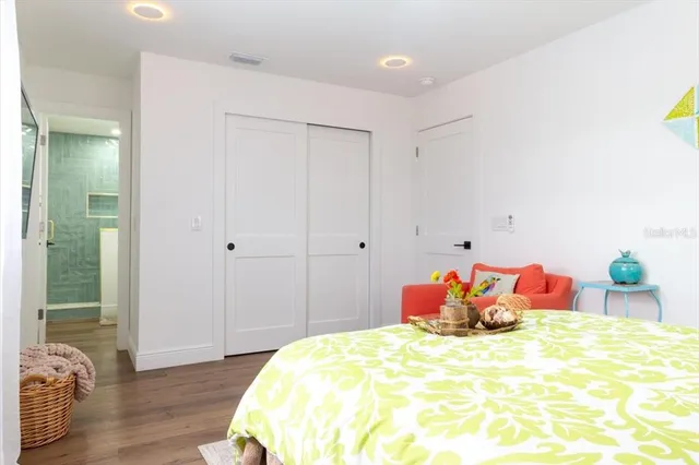a bathroom with a granite countertop sink a toilet and shower