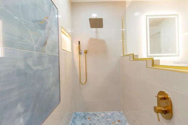 a bathroom with a sink a light fixture and a mirror