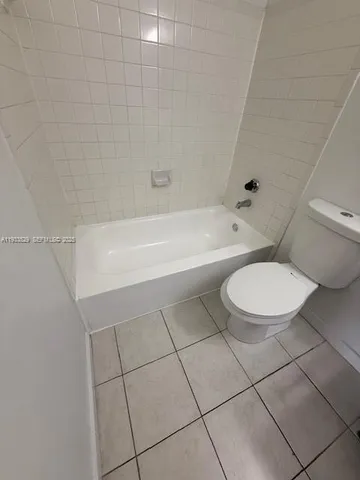 a bathroom with a toilet a sink and bathtub