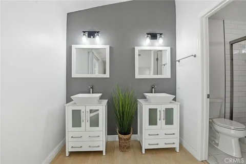 a bathroom with a toilet a sink and mirror
