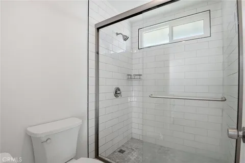 a bathroom with a shower and toilet