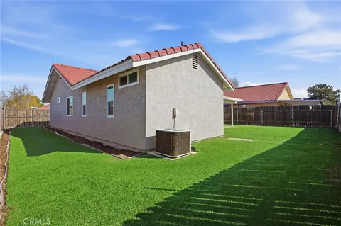 a front view of house with a garden