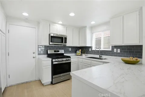 a kitchen with a stove a sink and a microwave