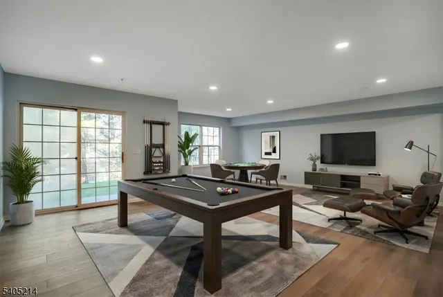 a living room with furniture a flat screen tv and a large window