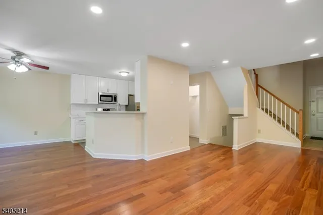 a view of a kitchen with wooden floor and electronic appliances