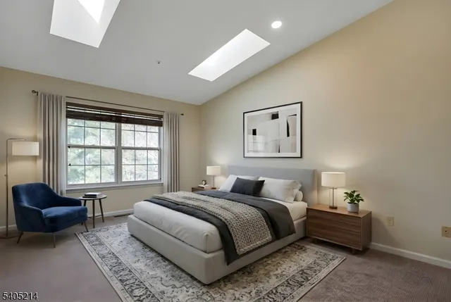 a spacious bedroom with a bed and glass window