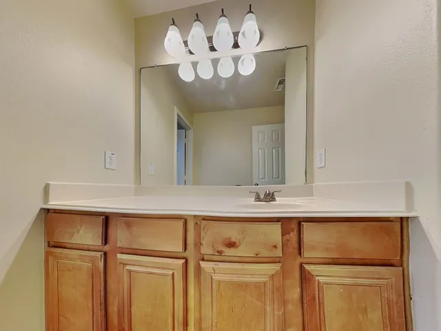 a view of an empty room with window and fire place