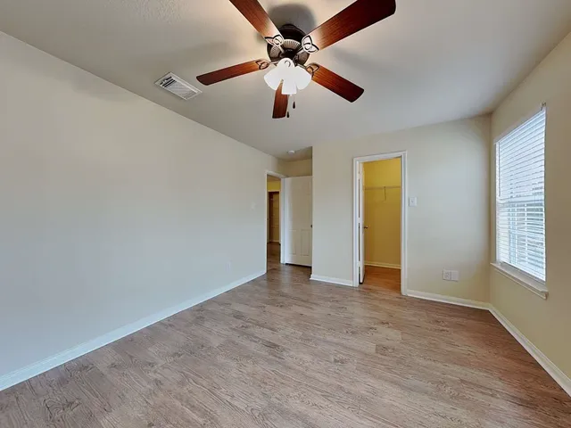 wooden floor in an empty room with a window