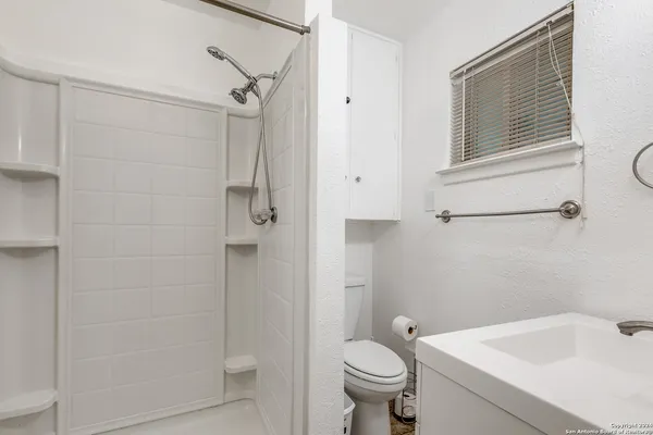 a bathroom with a sink and shower