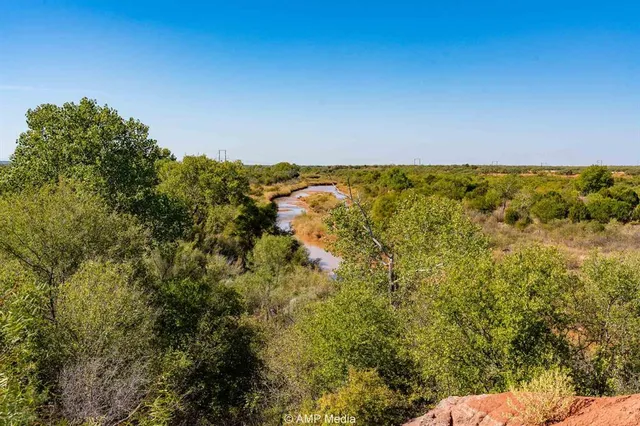 a view of a lake with houses in the back