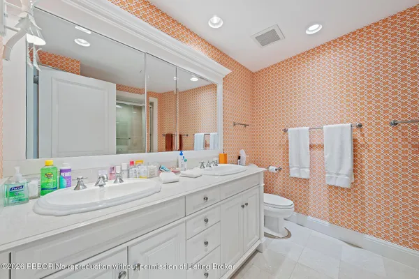 a bathroom with a granite countertop sink mirror and a toilet