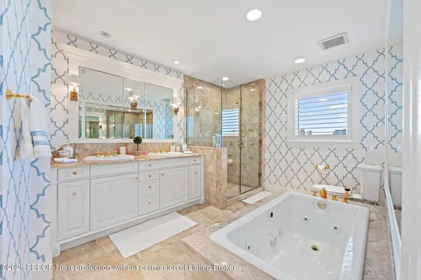 a bathroom with a sink mirror and a bathtub