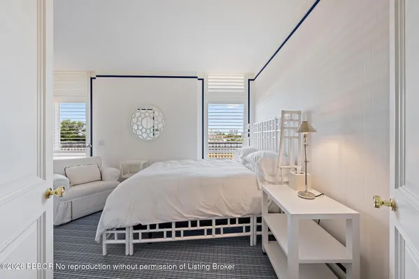 a living room with a bed furniture and a window