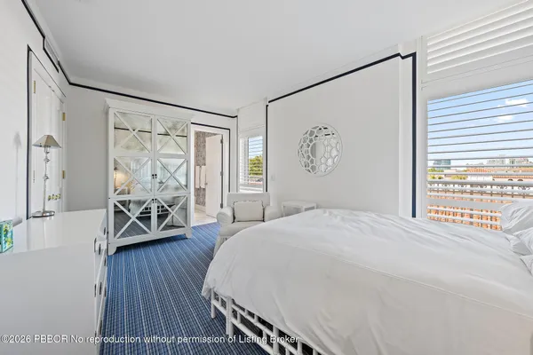a bedroom with a large bed and a window