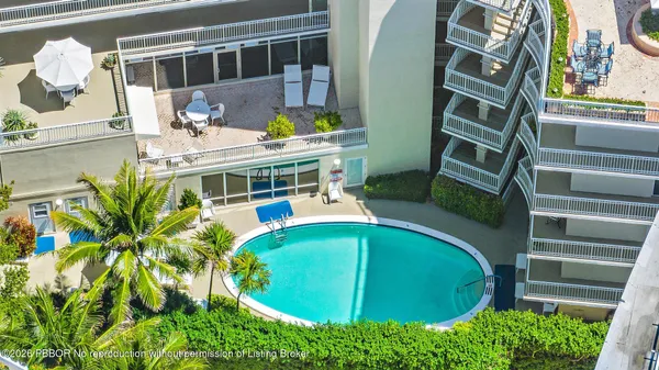 a view of balcony with a swimming pool and outdoor seating