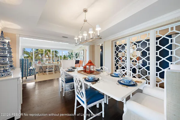 a view of a dining room with furniture and chandelier