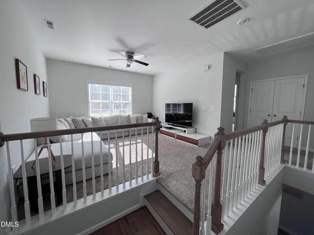 a view of entryway livingroom and hall with wooden floor