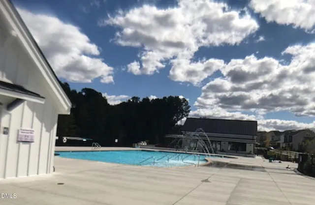 a view of a swimming pool with a yard