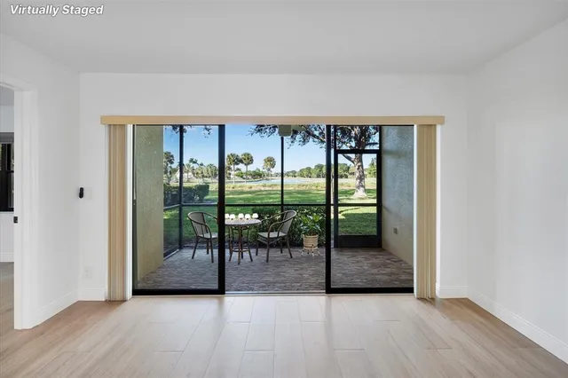 an empty room with sliding door and mountain view