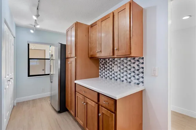 a kitchen with stainless steel appliances granite countertop a refrigerator sink and cabinets
