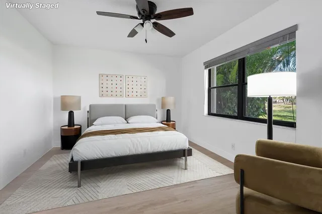 a bedroom with a bed a couch and a window