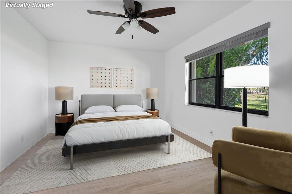 2900 Southwest 22nd Circle, Unit 221E Delray Beach, FL 33445 - Photo 13 of 43 a bedroom with a bed a couch and a window