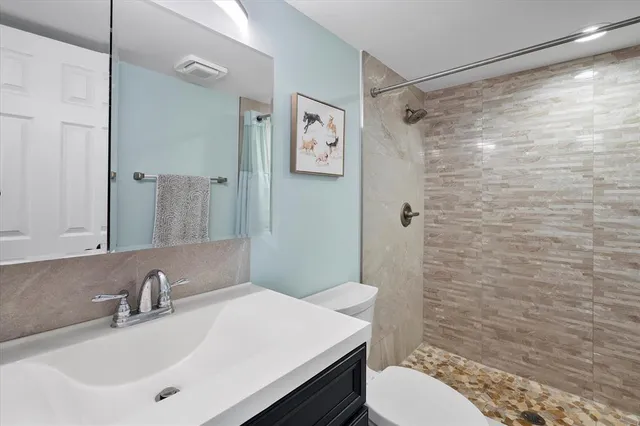 a bathroom with a sink toilet and shower