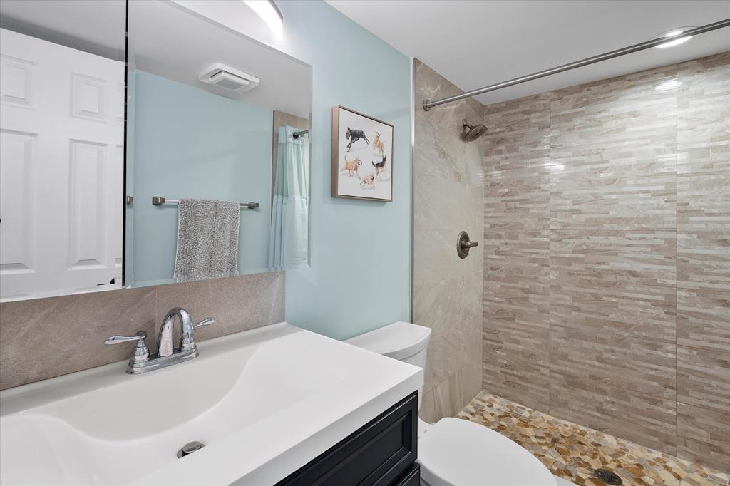 2900 Southwest 22nd Circle, Unit 221E Delray Beach, FL 33445 - Photo 16 of 43 a bathroom with a sink toilet and shower