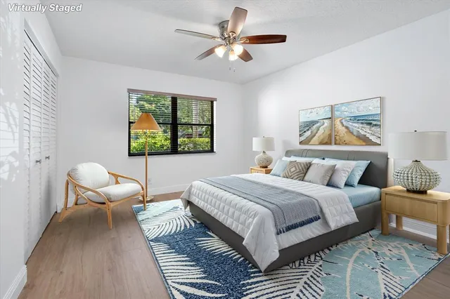 a bedroom with a bed wooden floor and window