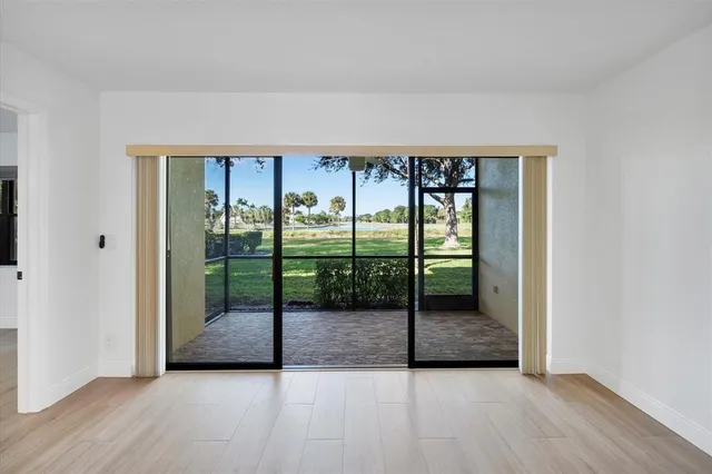 an empty room with sliding glass door and door
