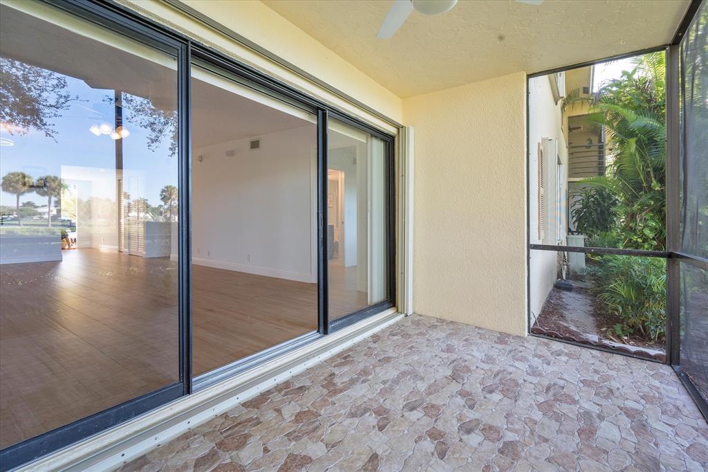 2900 Southwest 22nd Circle, Unit 221E Delray Beach, FL 33445 - Photo 26 of 43 a view of livingroom with furniture and floor to ceiling window