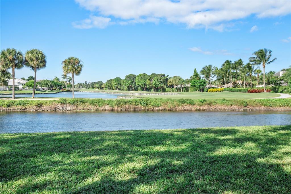 2900 Southwest 22nd Circle, Unit 221E Delray Beach, FL 33445 - Photo 28 of 43 a view of a lake with houses in the back