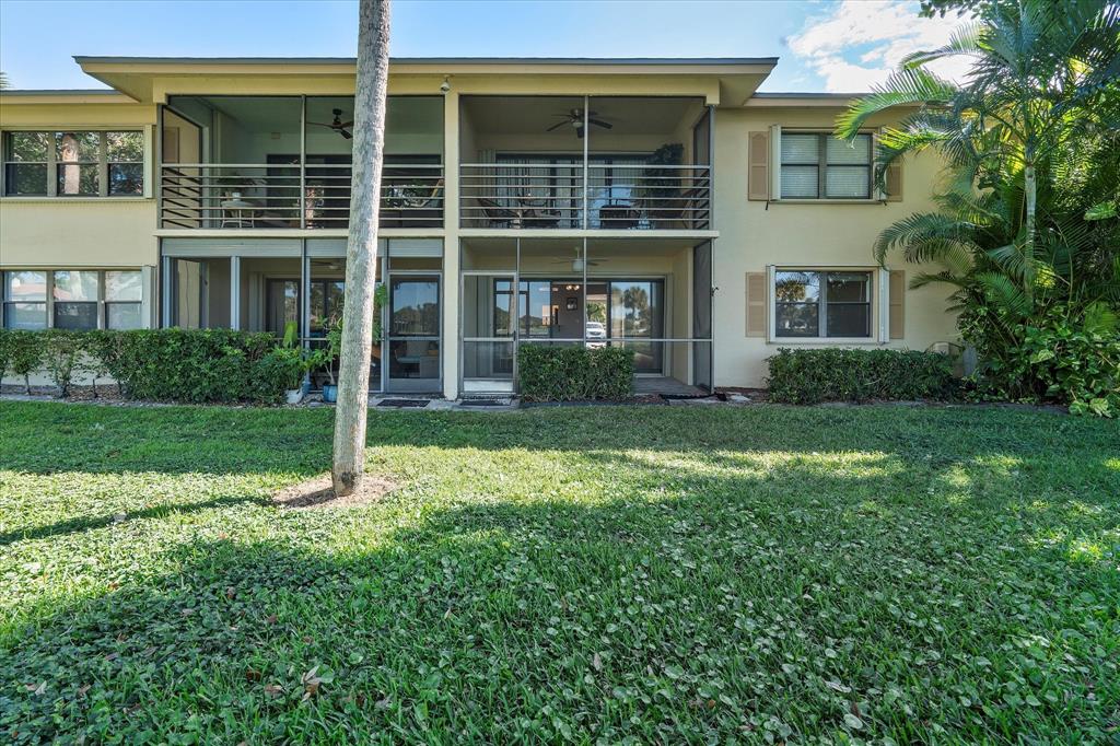 2900 Southwest 22nd Circle, Unit 221E Delray Beach, FL 33445 - Photo 29 of 43 a view of house in front of a yard with potted plants