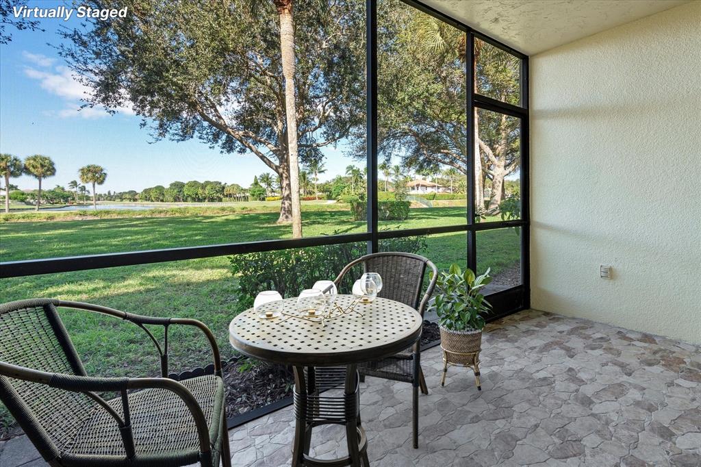 2900 Southwest 22nd Circle, Unit 221E Delray Beach, FL 33445 - Photo 3 of 43 a backyard of a house with table and chairs