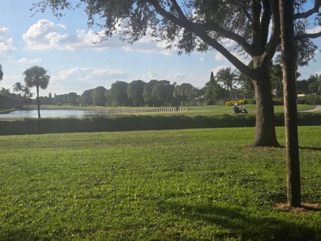 2900 Southwest 22nd Circle, Unit 221E Delray Beach, FL 33445 - Photo 38 of 43 a view of lake with green yard