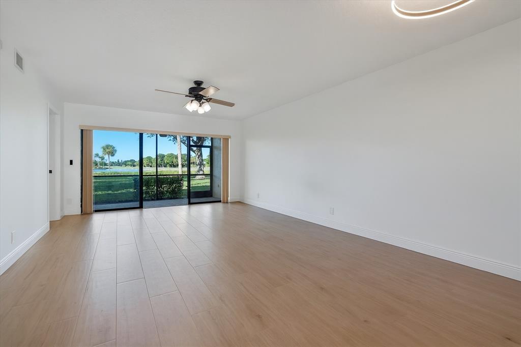 2900 Southwest 22nd Circle, Unit 221E Delray Beach, FL 33445 - Photo 7 of 43 wooden floor in an empty room with a window