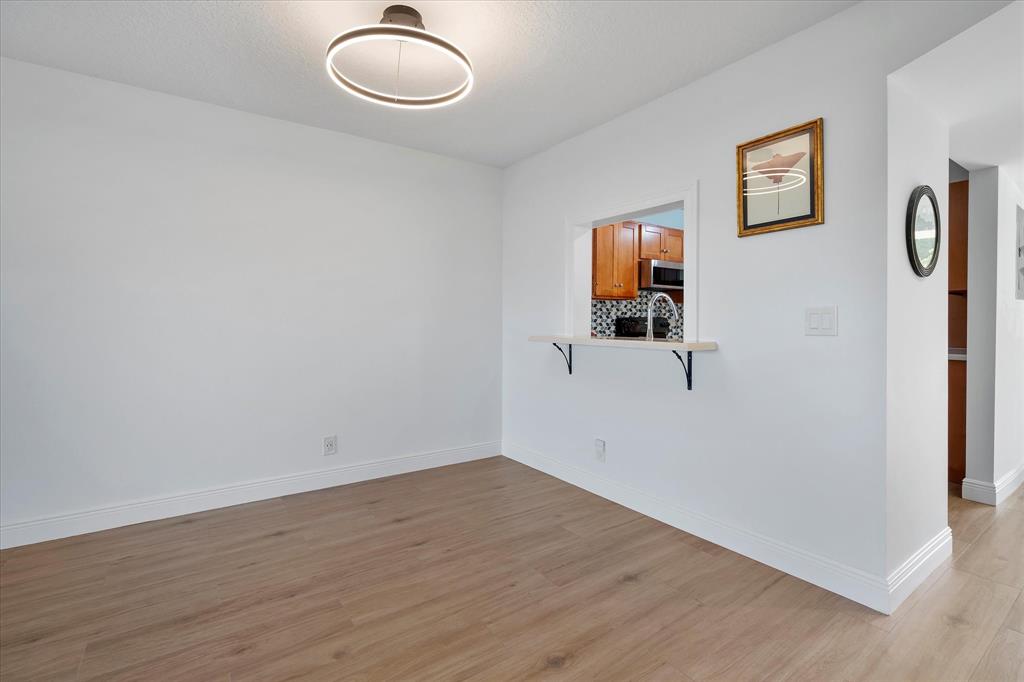 2900 Southwest 22nd Circle, Unit 221E Delray Beach, FL 33445 - Photo 9 of 43 wooden floor in an empty room