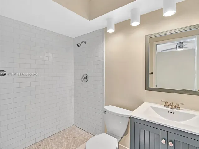 a view of staircase with railing and white walls