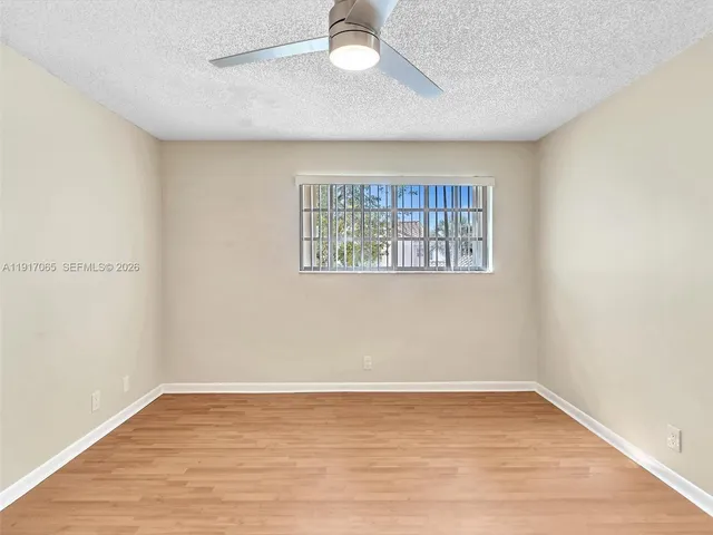 a bathroom with a granite countertop sink a bathtub and next to a window
