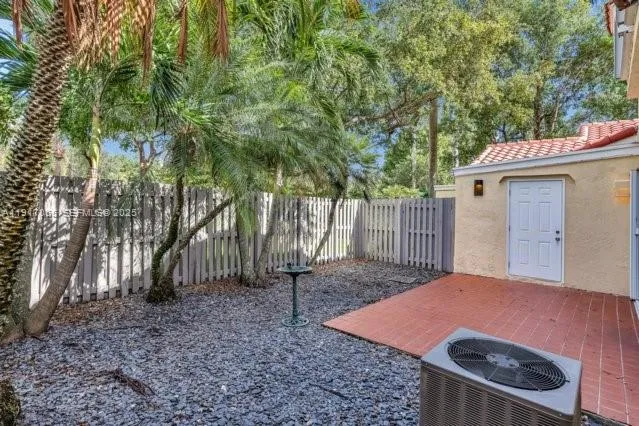 a view of sign board with street and trees