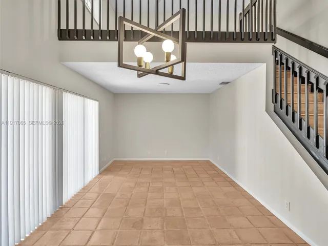 a view of staircase with white walls and a window