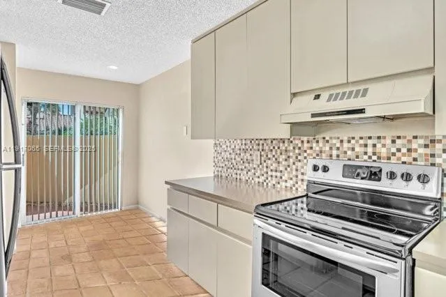 a kitchen with a sink stove and refrigerator